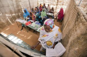 A view inside Abu Shouk Internally Displaced Persons (IDP) Camp's Women Center, in North Darfur, Sudan, where classes are offered in Arabic, the Koran and Mathematics. Approximately 80 women attend the classes, usually taking their children along with them. UN Photo/Albert Gonzalez Farran.