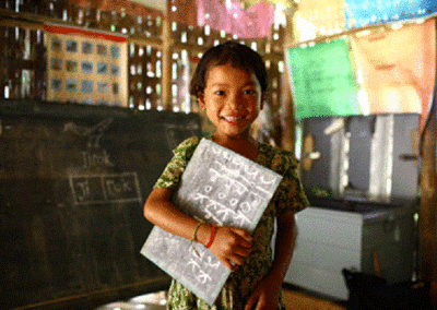 Child with a book  under her arm in class