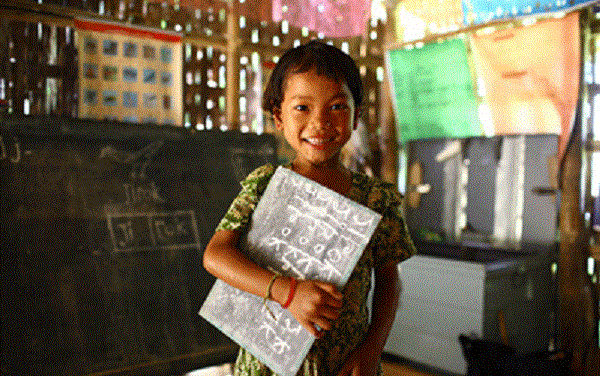 Child with a book  under her arm in class