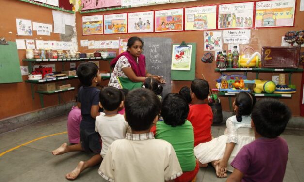 A teacher and children in class in India