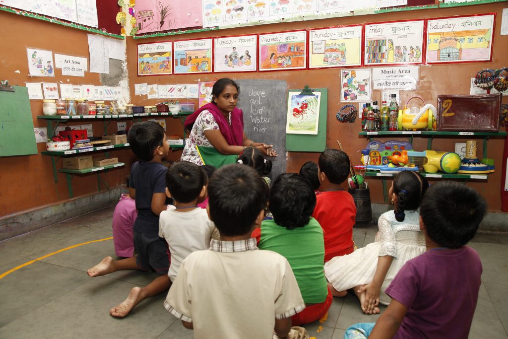 A teacher and children in class in India