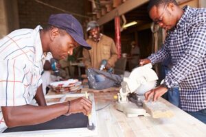 Developing Capabilities - Three South African men in a carpentry workshop 