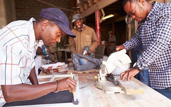 Developing Capabilities - Three South African men in a carpentry workshop