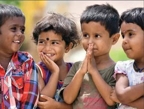 Four smiling primary age children