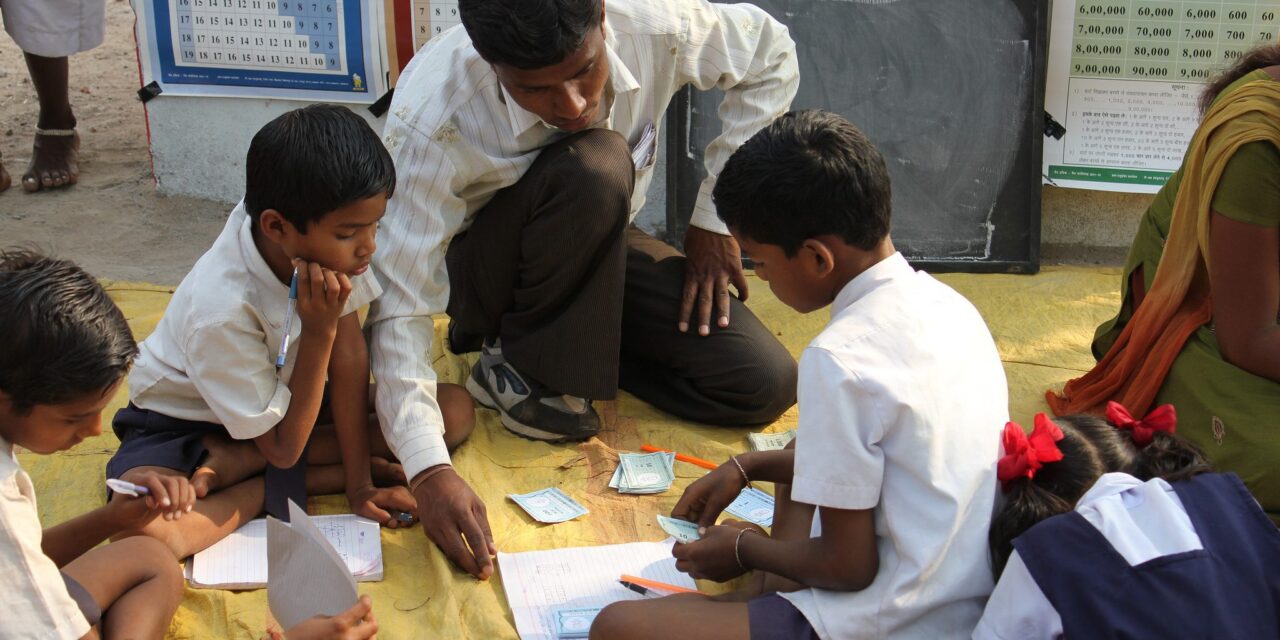 teacher supporting pupils in class