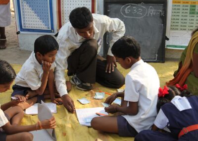 teacher supporting pupils in class