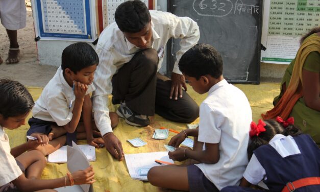 teacher supporting pupils in class