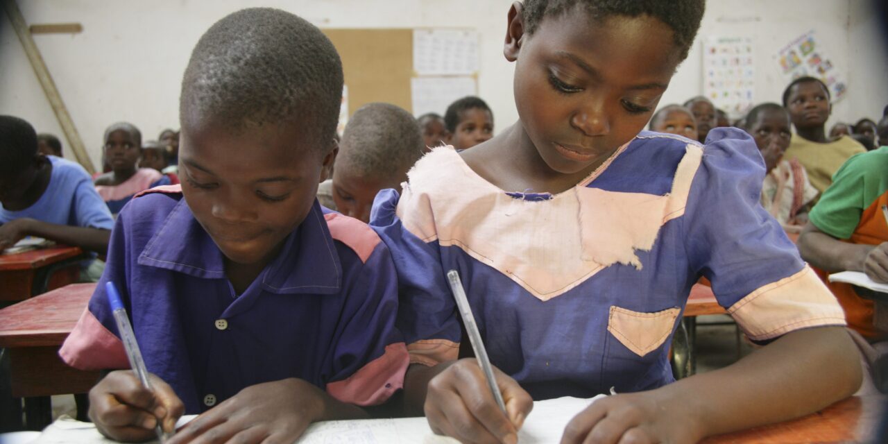 Children writing in a primary classroom in Malawi