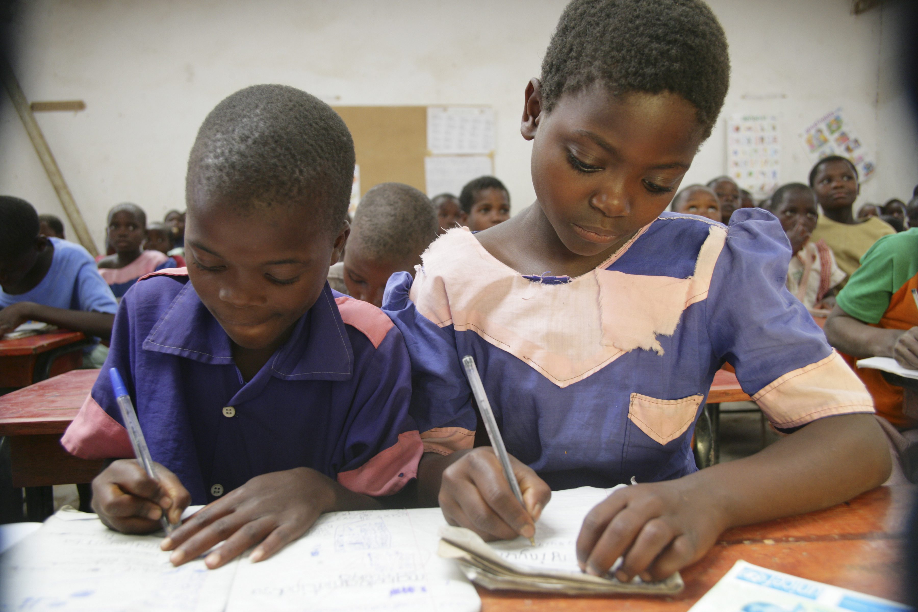 Children writing in a primary classroom in Malawi