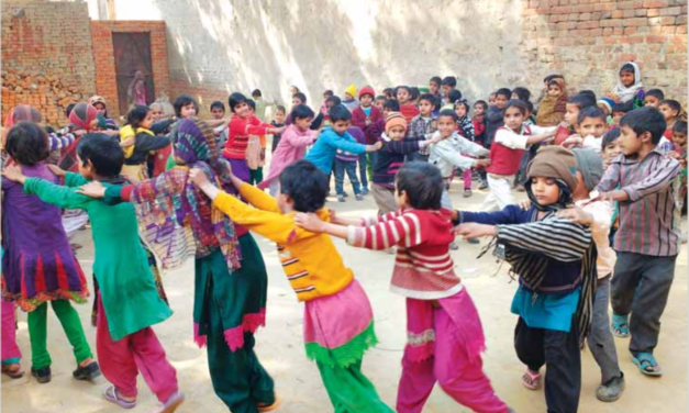 Children playing in a ring with their hands on the shoulders of the child in front