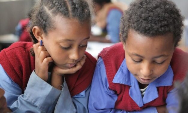 Two girls reading in a class in Ethiopia