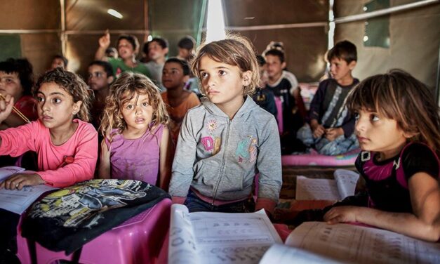 Children in a classroom in a tent