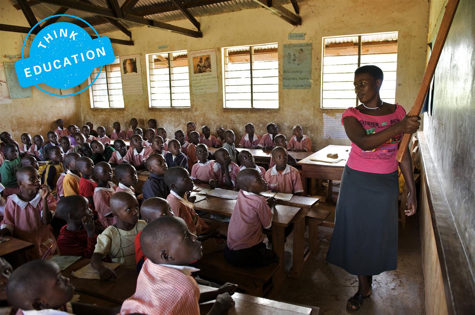 A teacher at the front of a large class of students