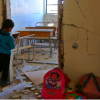 Education Under Attack 2018 A Syrian child looks into a school classroom damaged during a reported air strike on March 7, 2017, in the opposition-held town of Utaya, near the city of Damascus.