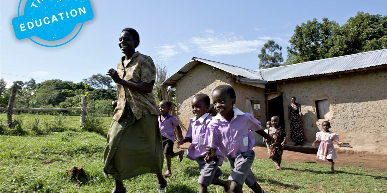 Think Education. Teacher and pupils running outside a school building