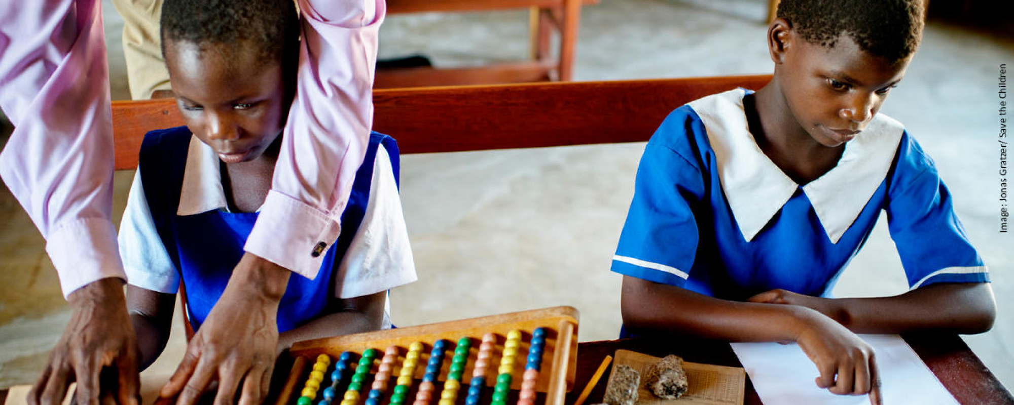 Teacher working with blind school children