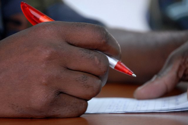 Hand holding a pen