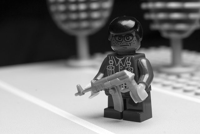 "Lego" type character holding a gun