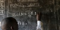 New research addresses global teaching crisis A teacher writes maths formulas on a blackboard at a school. Image Credit_Philippe-Lissac_Godong_Panos-Pictures