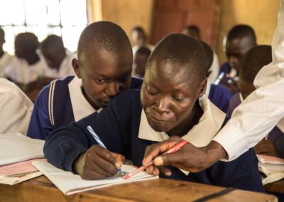 Teacher supporting boys in class