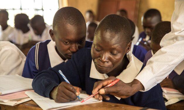 Teacher supporting boys in class