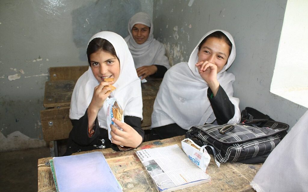 girls sitting at desks in class