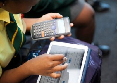 child using a tablet device and calculator