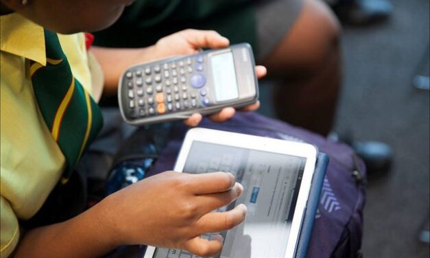 child using a tablet device and calculator