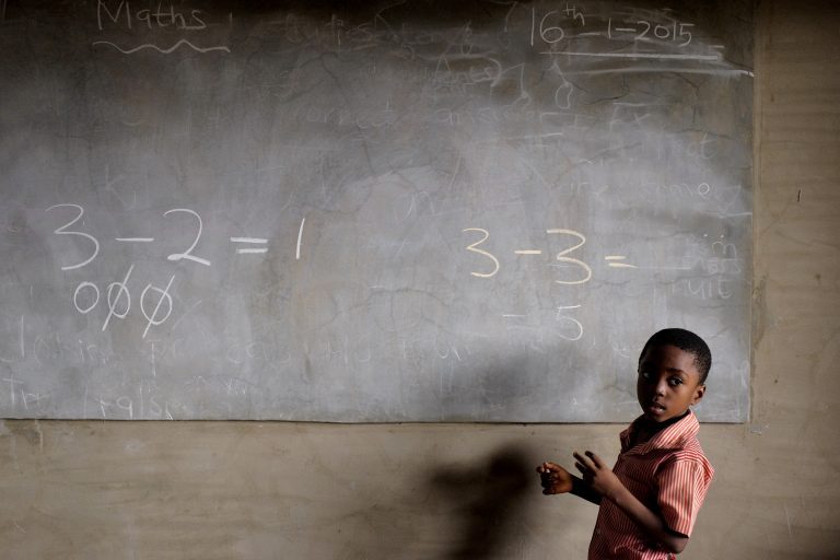 Child in front of a blackboard