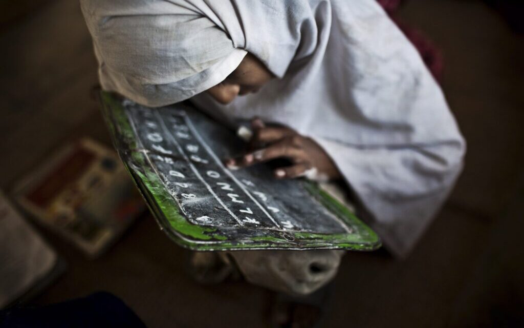 A student practices her english at the Girls' Government Primary School Syad Alipur. The school is located in the remote Panchkasi village, has no running water, no electricity and and no desks.