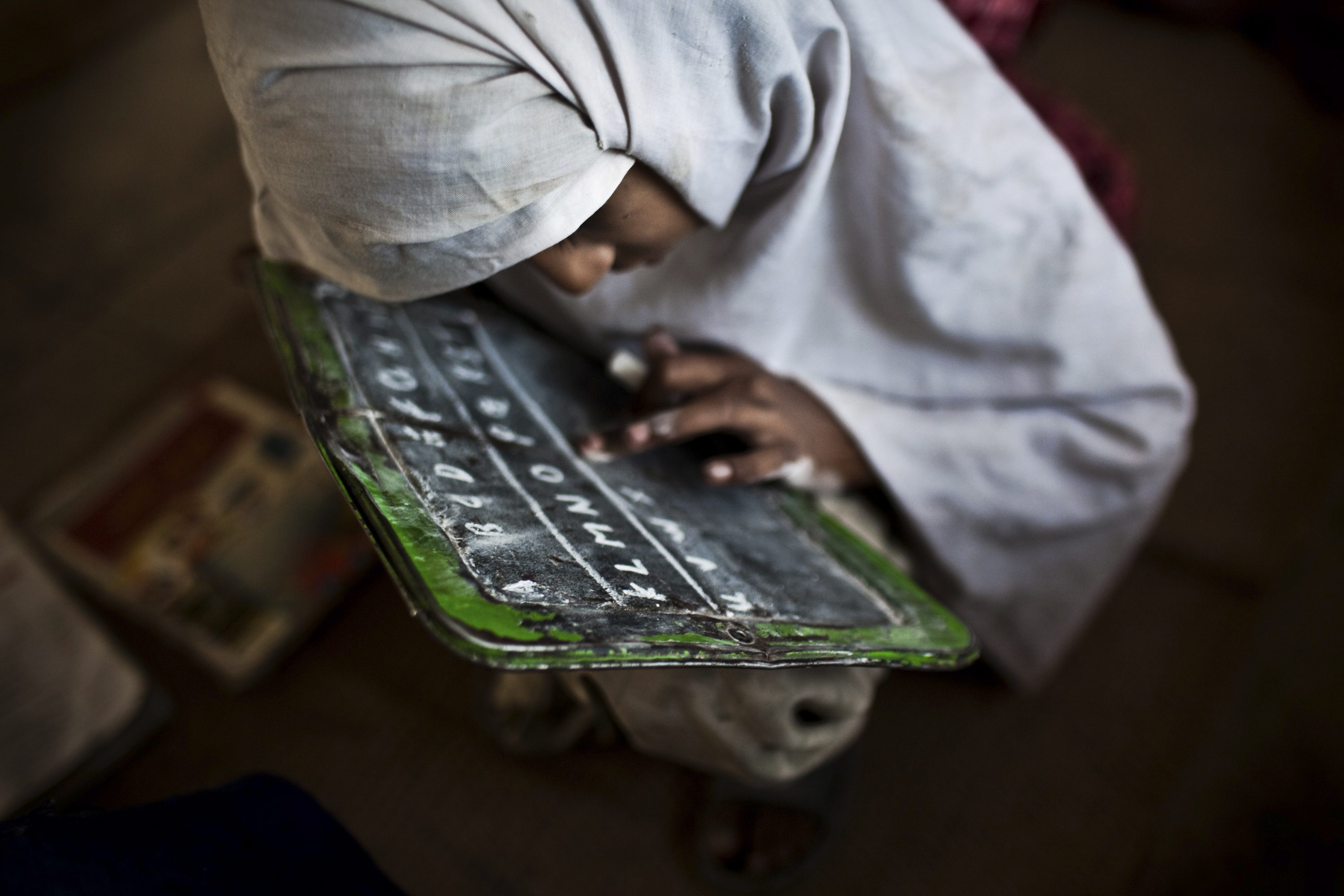 A student practices her english at the Girls' Government Primary School Syad Alipur. The school is located in the remote Panchkasi village, has no running water, no electricity and and no desks.