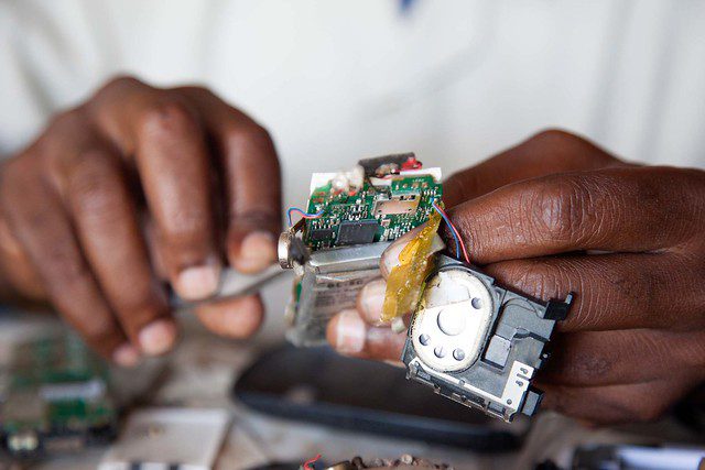 hands working on an electrical component