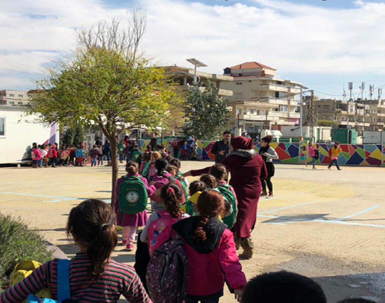 School children gathering in class groups in school yard