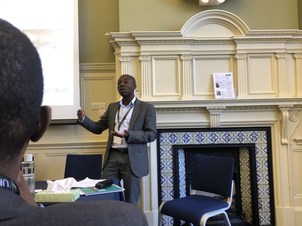 A male presenter at the conference