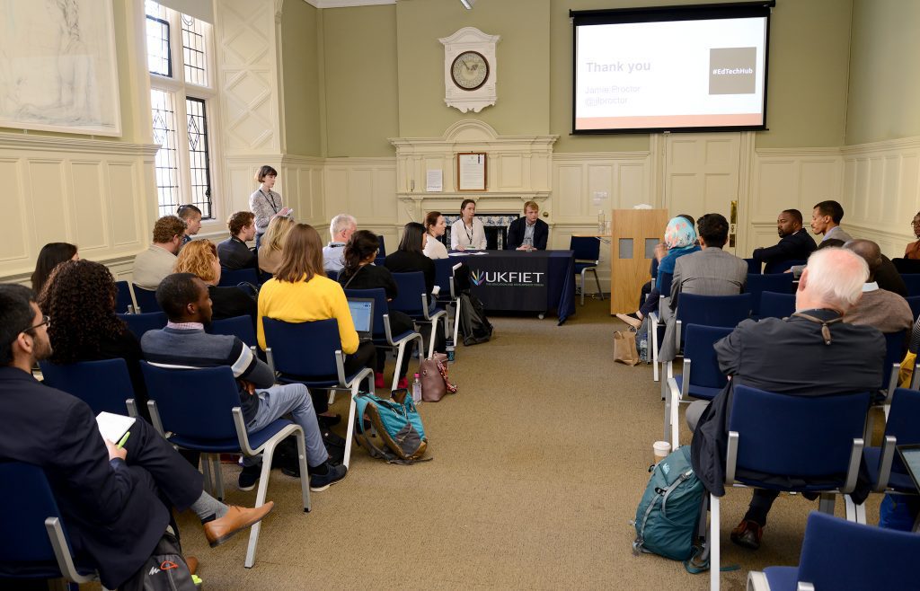 A paper session at the conference looking from the back of the room to presenters