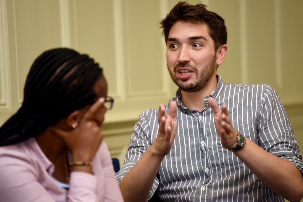 male delegate explaining something at the conference