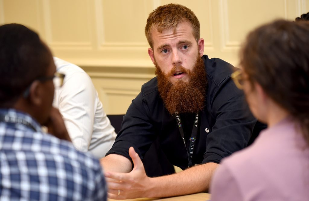 male delegate in discussion at the conference