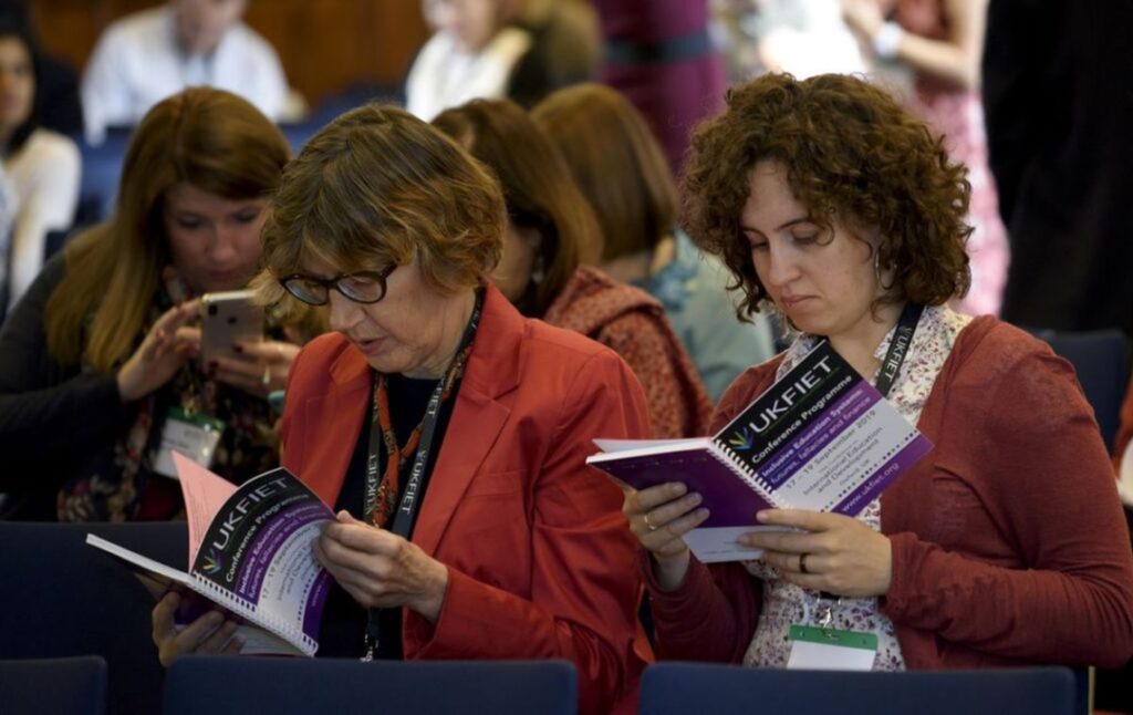 Delegates referring to conference programme 2019