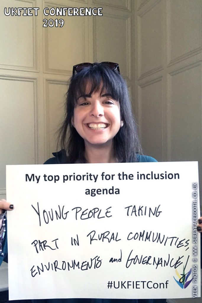 Daniella Rabino holds up a card My top priority for the inclusion agenda - Young people taking part in rural communities, environments and governance!