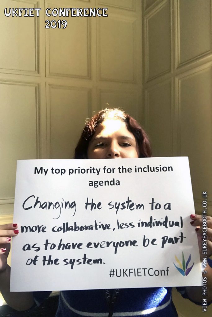 Nidia Aviles holds up a card My top priority for the inclusion agenda: Changing the system to a more collaborative, less individual as to have have everyone be part of the system