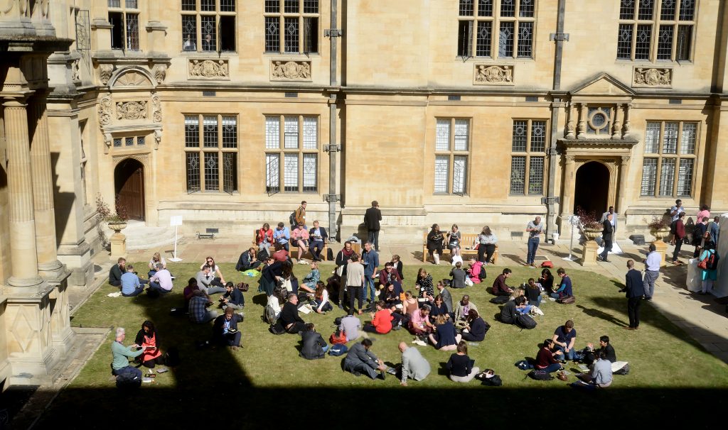 Delegates sitting on the grass at lunchtime  2019