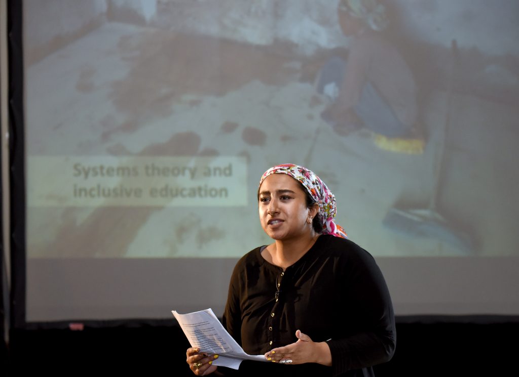 A female actor playing Abebe at the conference