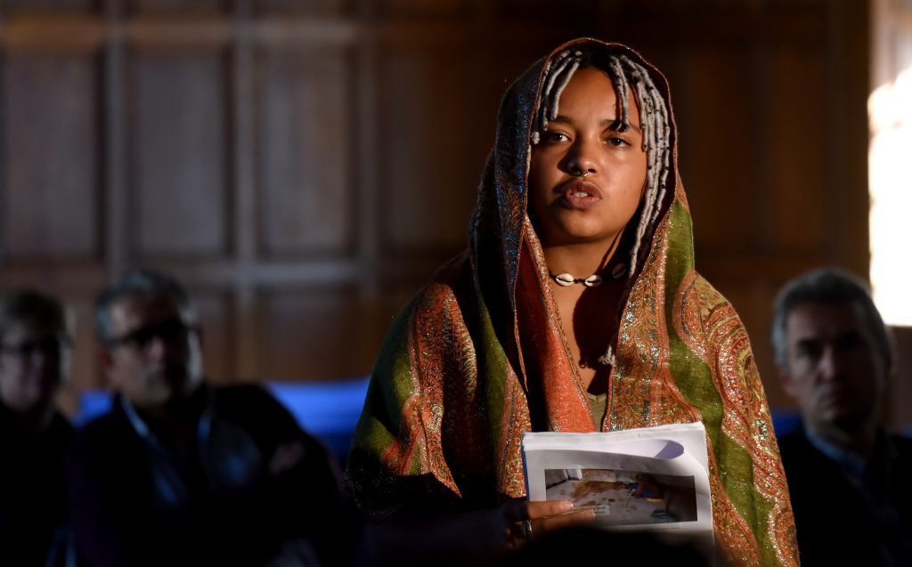 A female actor playing Mrs Ansha at the conference