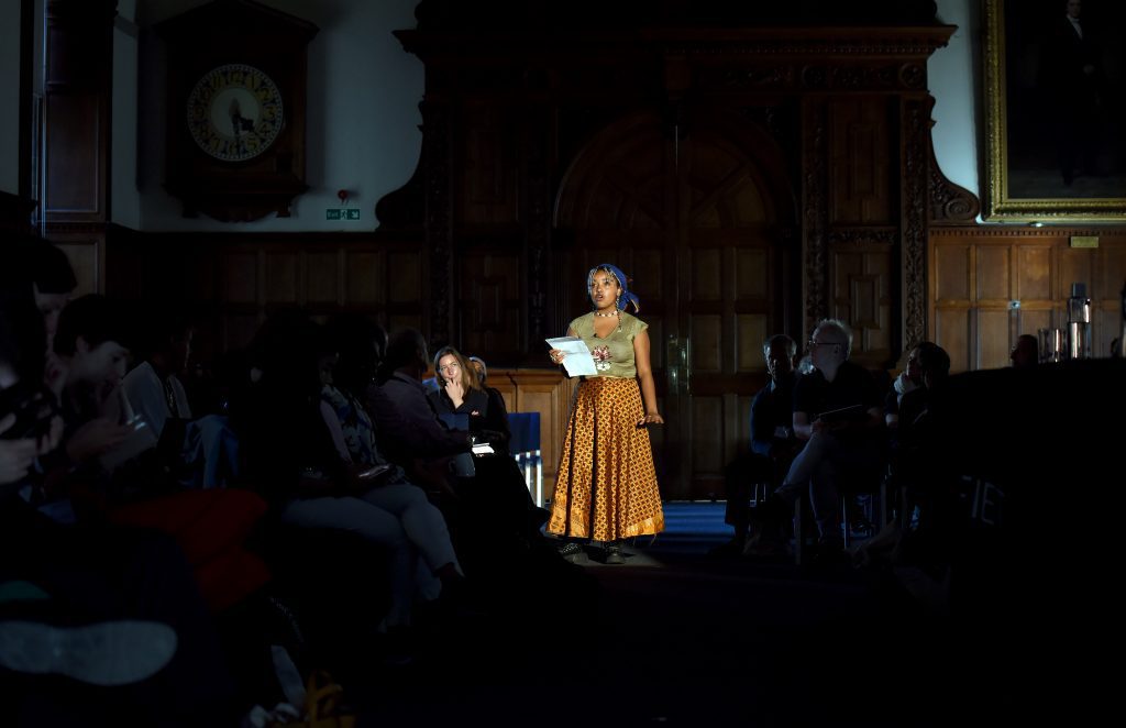 A male actor playing "Francisca, a social worker working with the women"