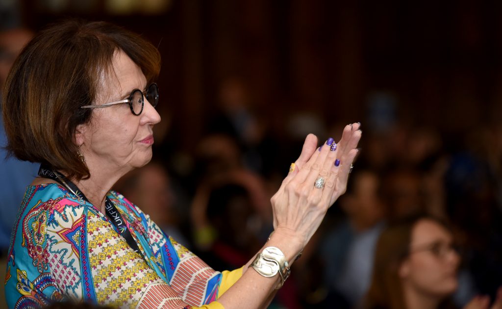 A female delegate clapping at the 2019 BAICE Plenary