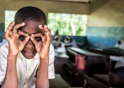 A student imitates a pair of glasses, during a screening excercise and spectacle distribution by Sightsavers at the Jongowe secondary school on Tumbatu island, Zanzibar.