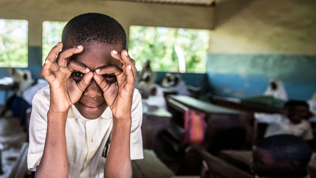 A student imitates a pair of glasses, during a screening excercise and spectacle distribution by Sightsavers at the Jongowe secondary school on Tumbatu island, Zanzibar.