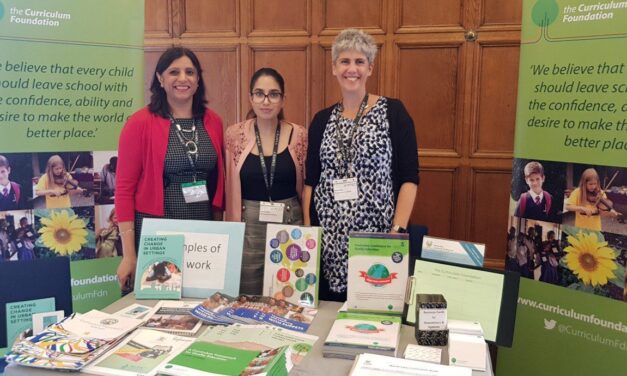 Curriculum Foundation exhibition stand at UKFIET Conference with three stand members