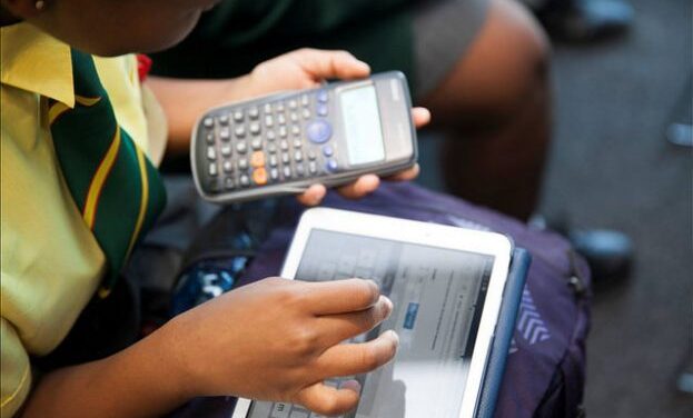 child with tablet and calculator
