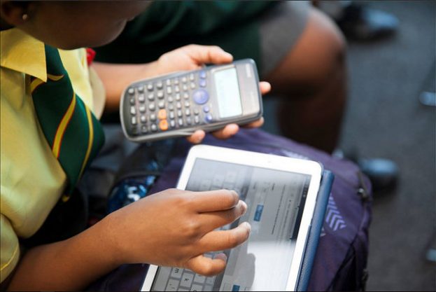 child with tablet and calculator